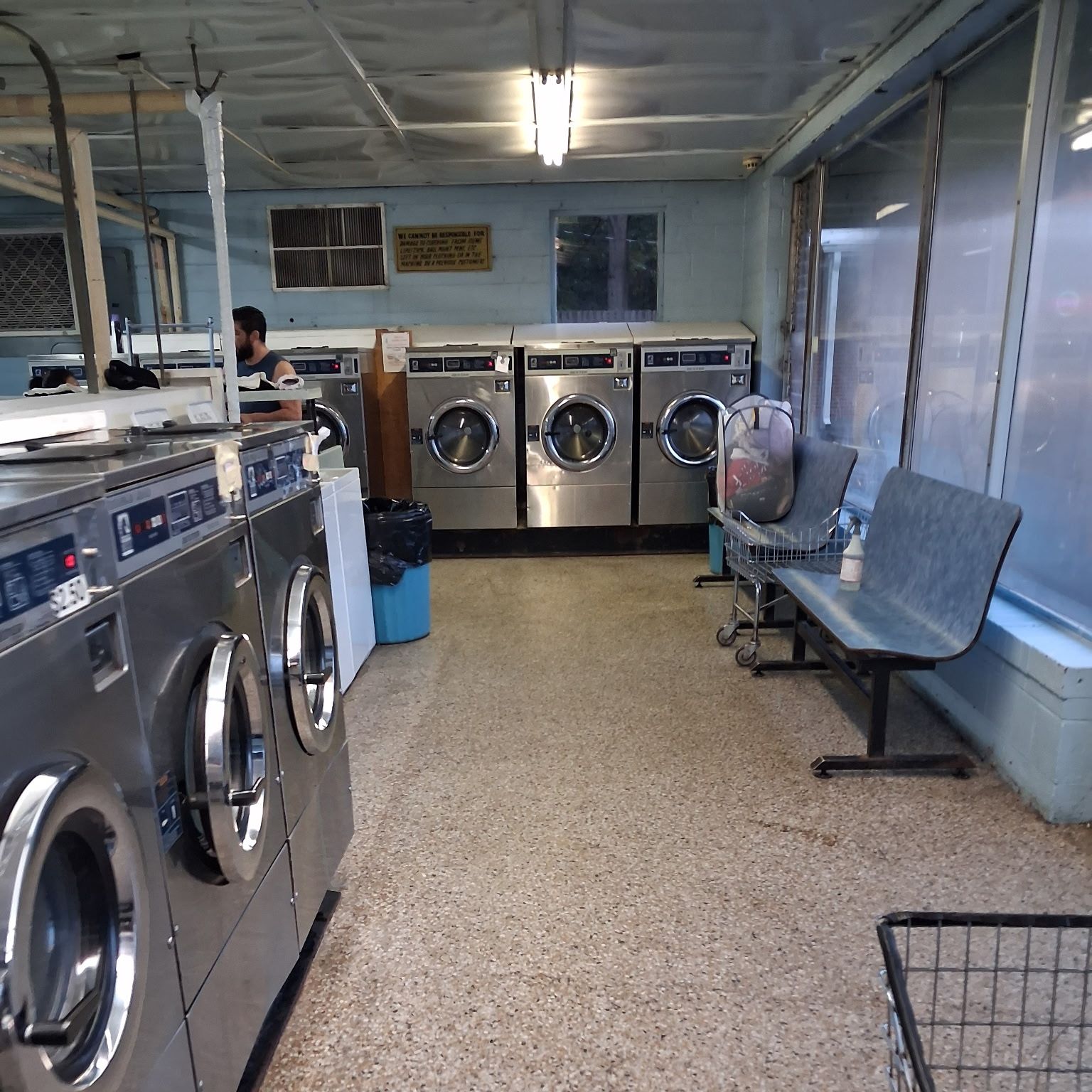 Laundry room aisle with the floor mopped between machine banks