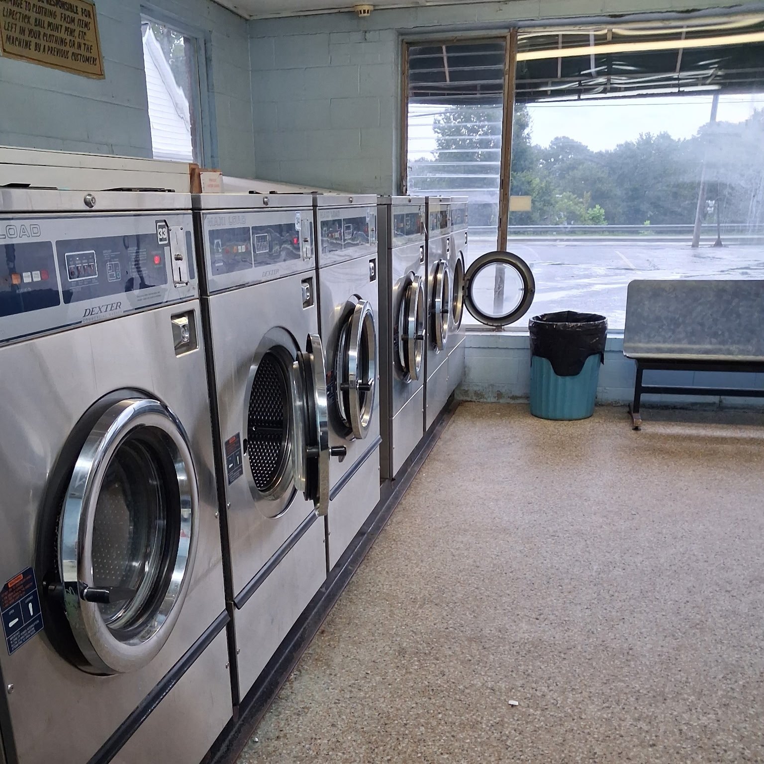 Front-load washers and the surrounding floor cleaned in a shared laundry room