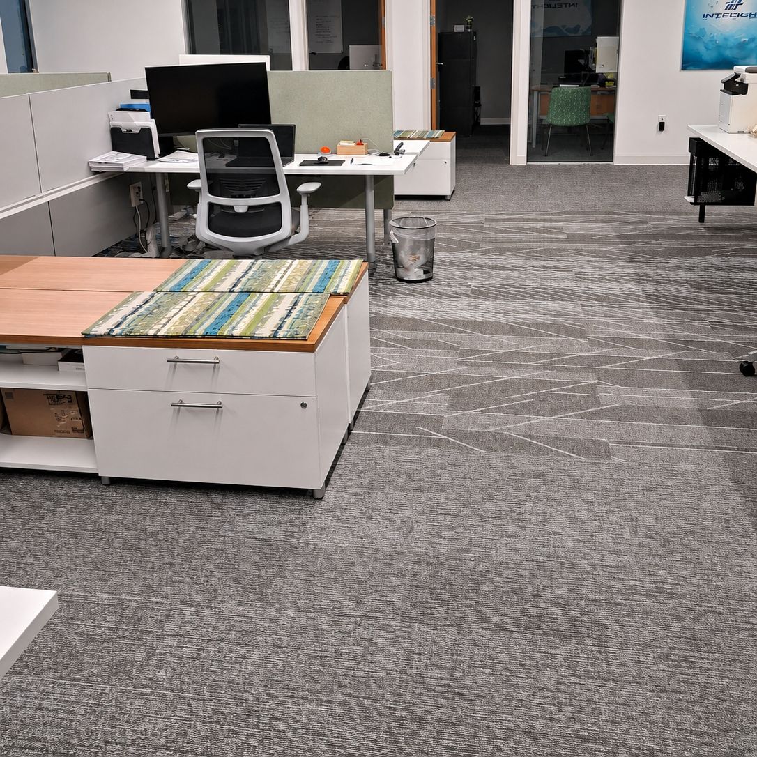 Row of open-plan workstations wiped down and reset before the next workday