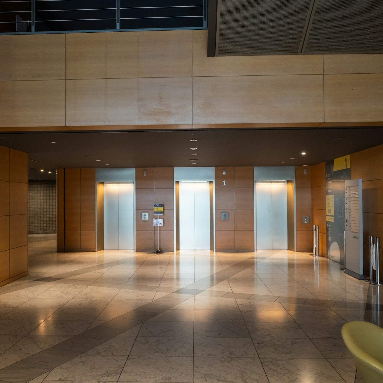 Shared elevator landing with the floor buffed and glass wiped