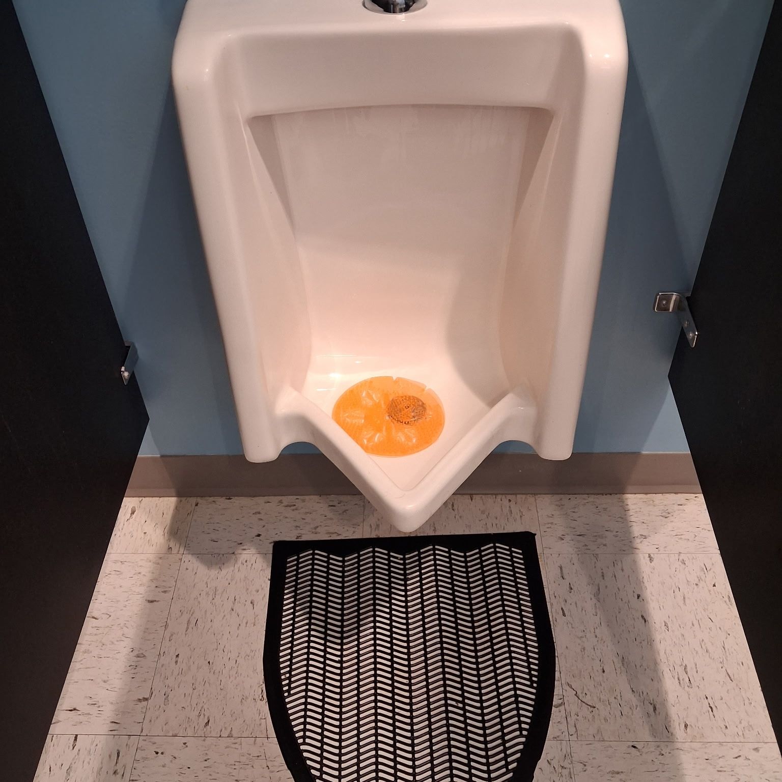 Commercial restroom urinal cleaned and disinfected during a scheduled visit