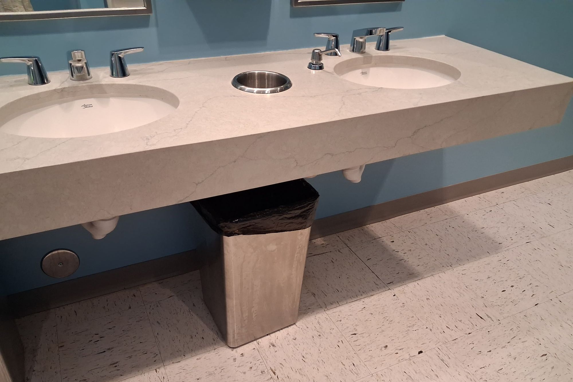 Restroom vanity counter and mirrors cleaned along the full run